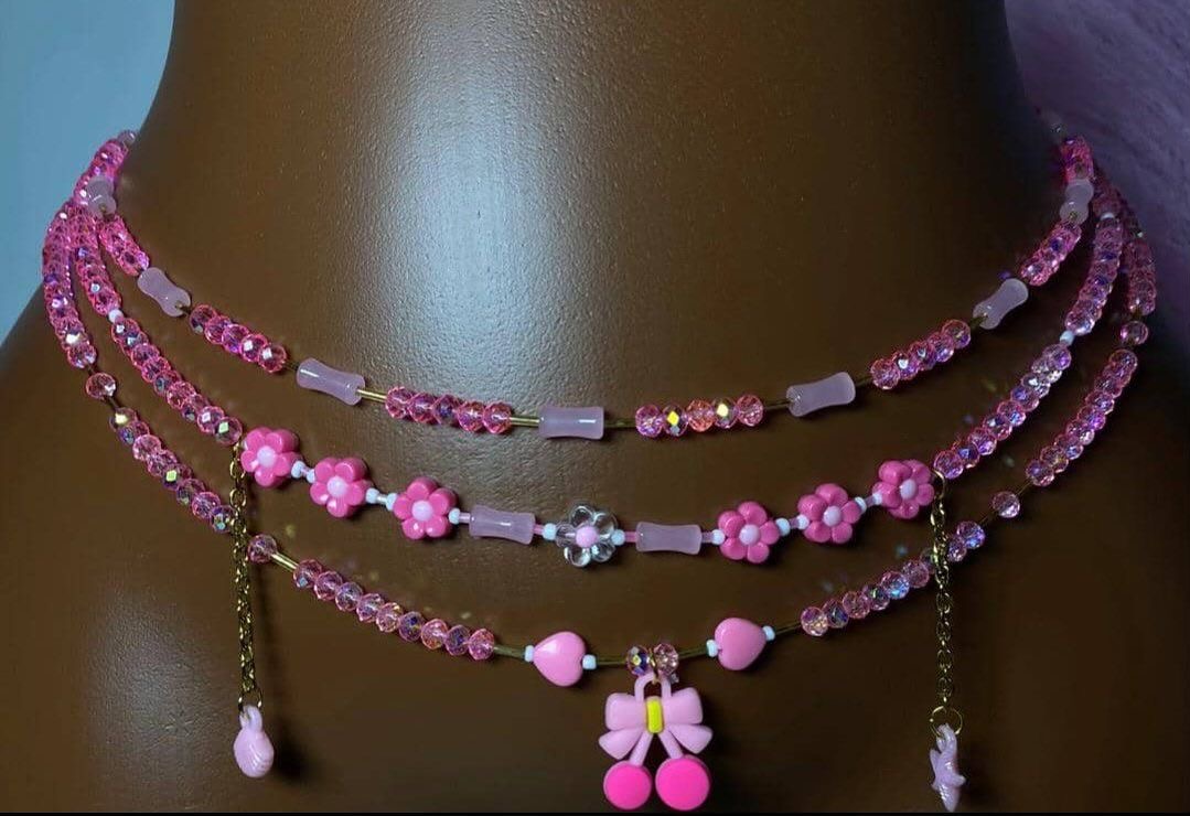 Layered pink crystal and flower beaded necklaces